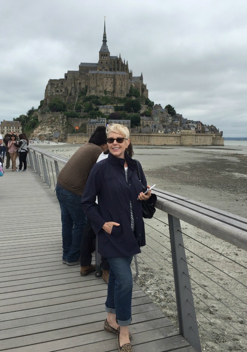 Susan B. of une femme d'un certain age wears an Eileen Fisher weather-resistant jacket. The current version of this jacket is on sale. 