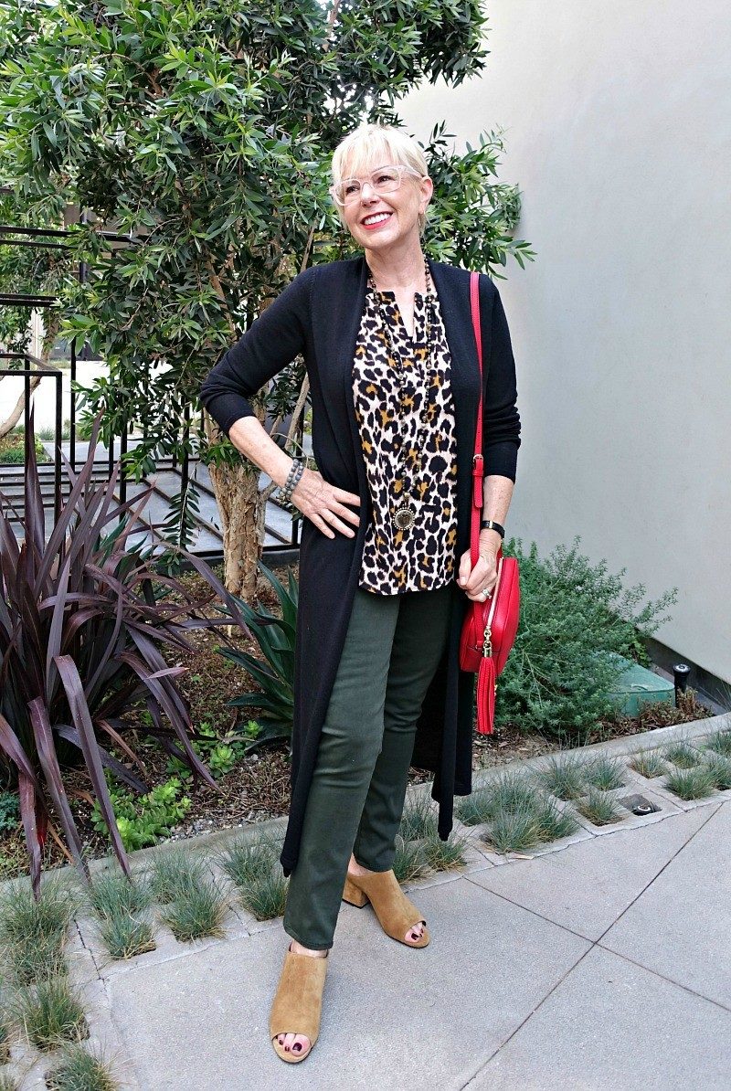 outfit with leopard print top, olive pants, red bag