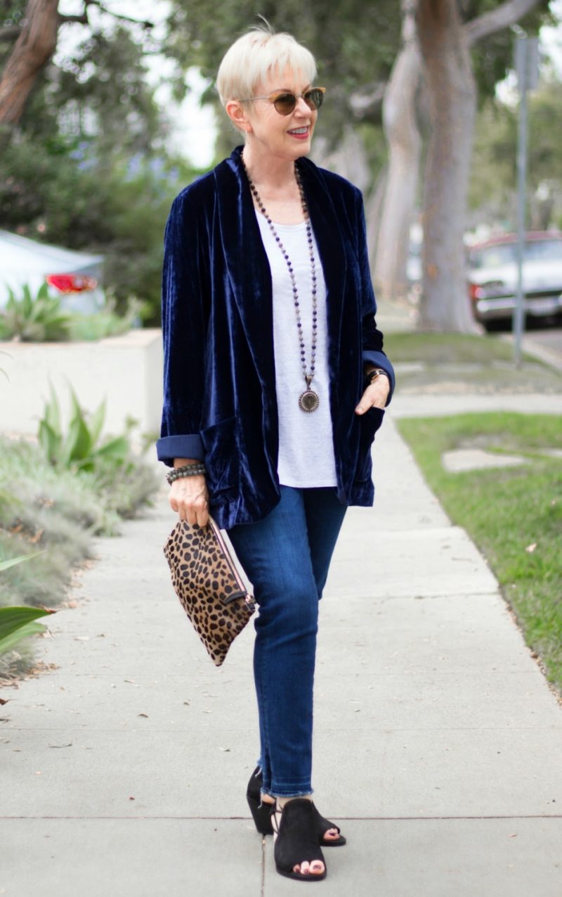 Style blogger Susan B. wears a navy velvet jacket, jeans and a leopard bag. Details at une femme d'un certain age.