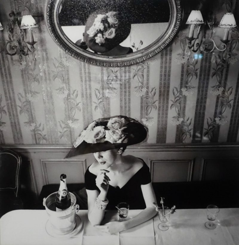 vintage fashion photo of woman with hat and champagne from Christian Dior exhibition in Paris. Details at une femme d'un certain age.