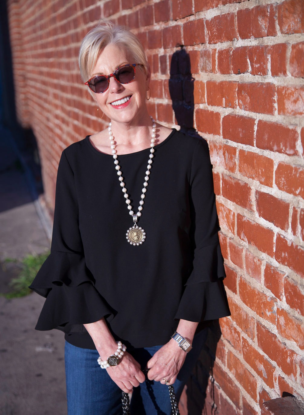 Susan B. wears a J.Crew statement sleeve top, and French Kande pearl jewelry. Details at une femme d'un certain age.