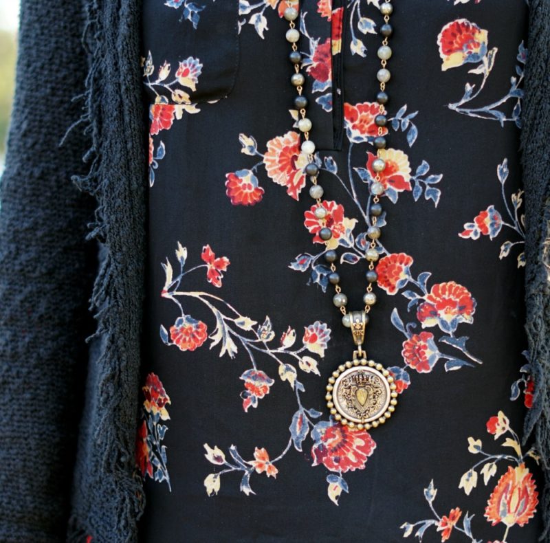 Outfit detail: French Kande necklace with silk floral blouse. Info at une femme d'un certain age.
