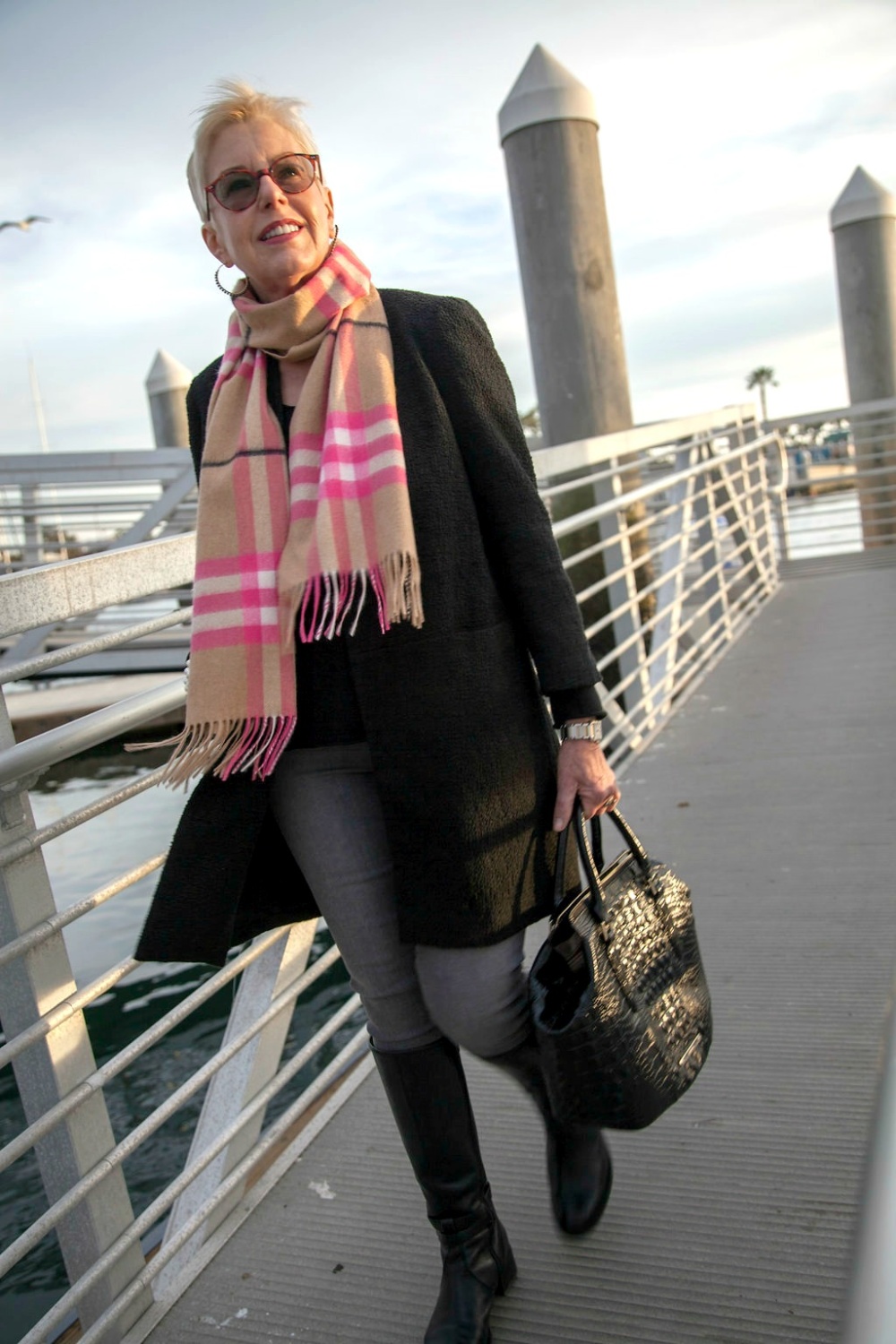 A touch of bright pink in this Burberry check scarf livens up a neutral outfit. Details at une femme d'un certain age.