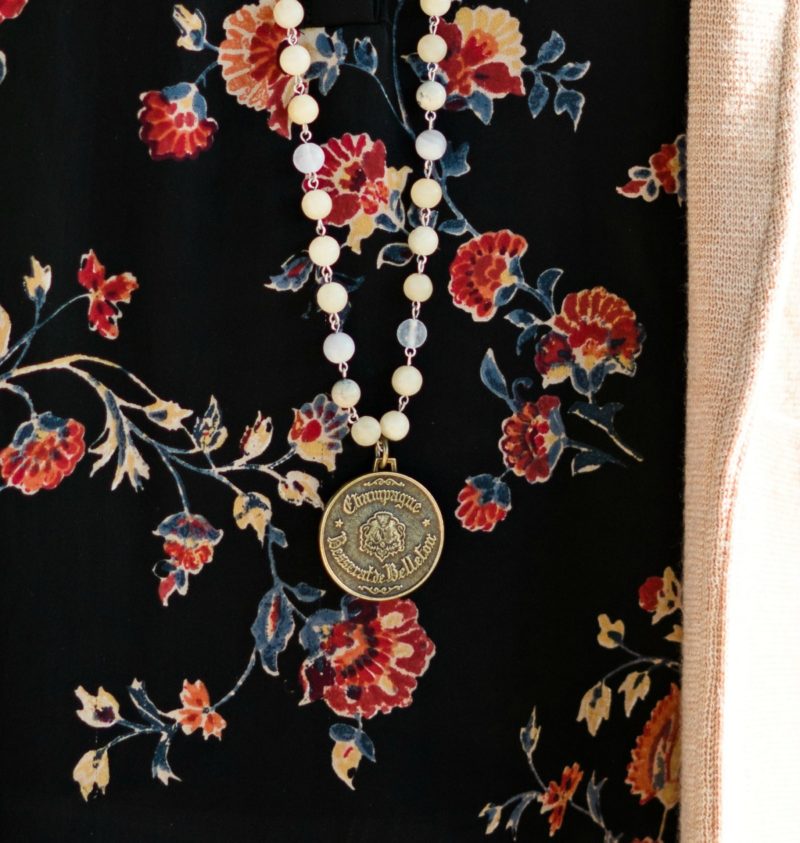 Floral top and necklace with vintage French medallion. Details at une femme d'un certain age.