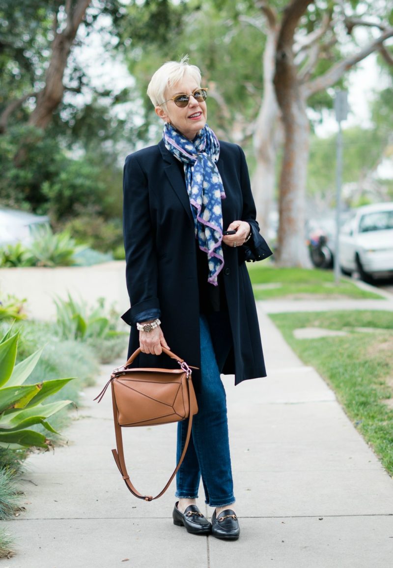 Polished casual outfit with long navy blazer, tan bag and horsebit loafers. Details at une femme d'un certain age.