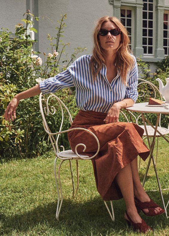 Dress like a Parisian: this blue and white stripe shirt and rust colored skirt from Sezane are very on-trend in Paris. Details at une femme d'un certain age.
