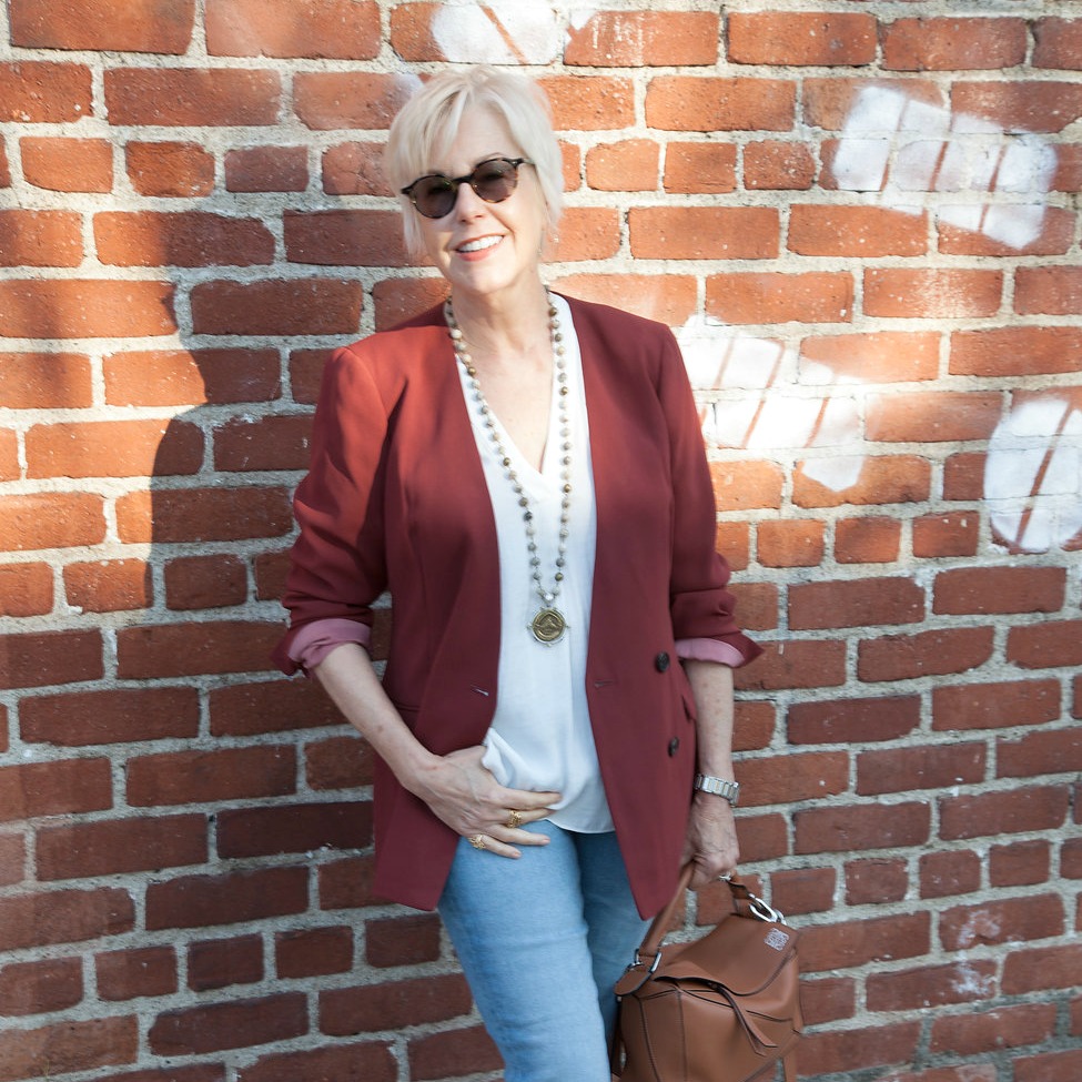 Style blogger Susan B. wears a J.Crew double-breasted jacket, French Kande necklace and Loewe bag. Details at une femme d'un certain age.