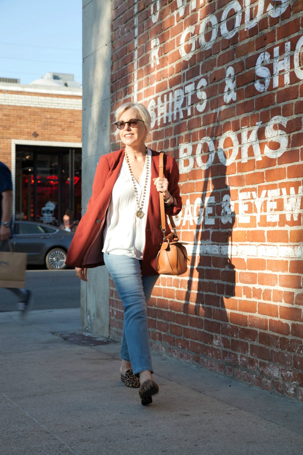 Style blogger Susan B. wears a casual denim look with a rust blazer. Details at une femme d'un certain age.