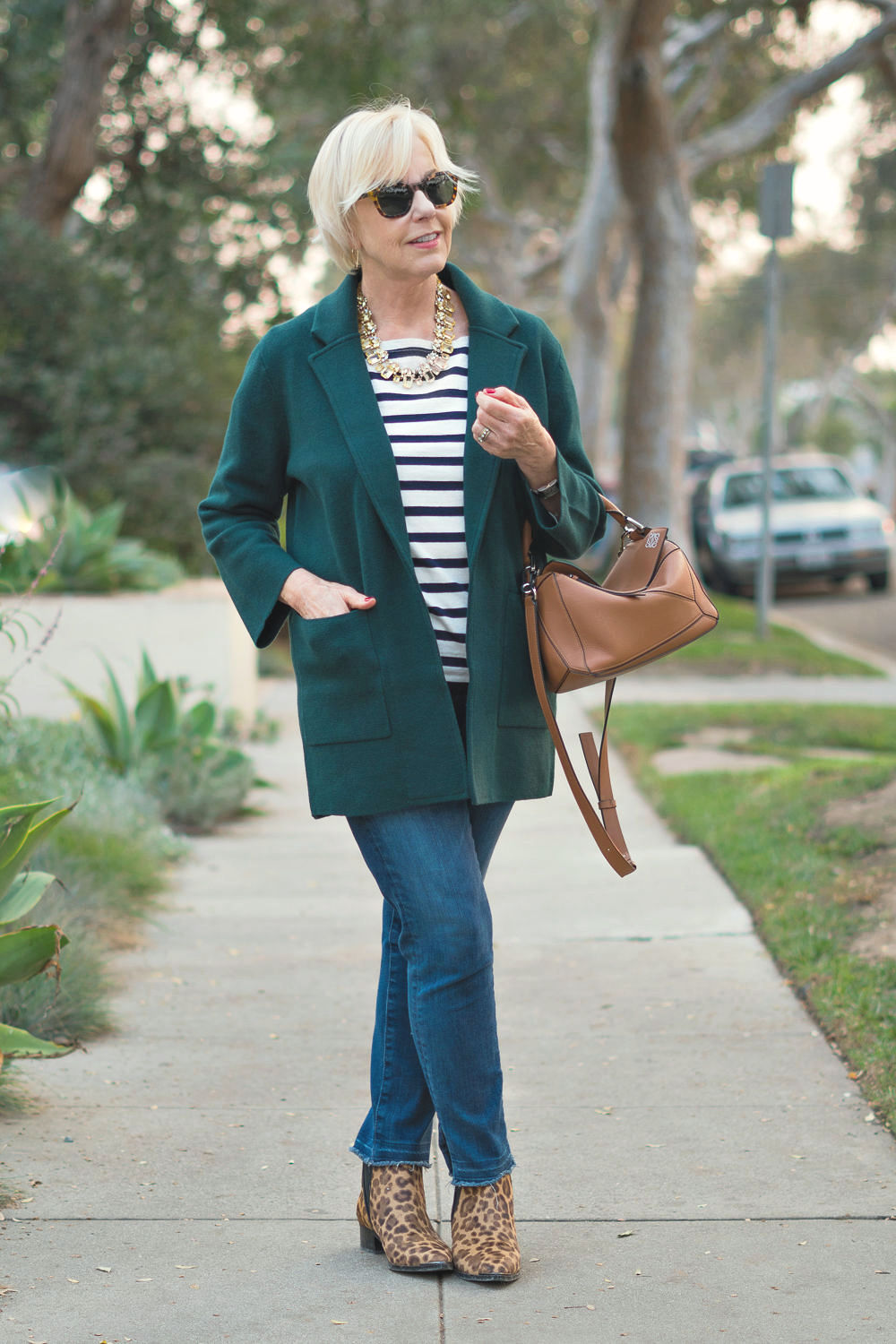 Style blogger Susan B. wears a J.Crew pine sweater jacket, striped tee, crystal necklace and leopard boots. Details at une femme d'un certain age.