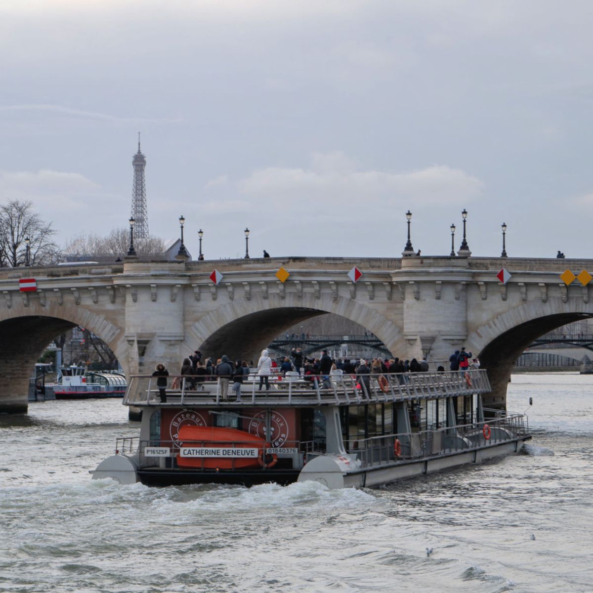 Paris: tour boat on the Seine named "Catherine Deneuve" with Eiffel tower in background. More at une femme d'un certain age.