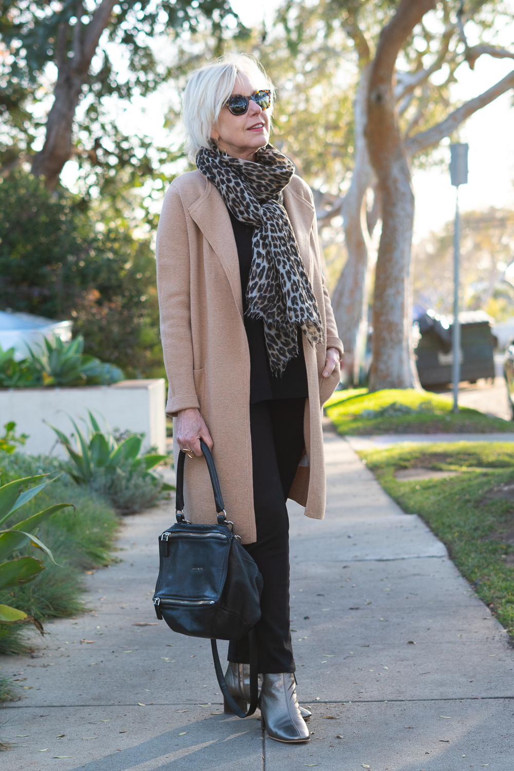 Style blogger Susan B. wears a camel J.Crew sweater-blazer over black separates, and metallic boots. Details at une femmme d'un certain age.