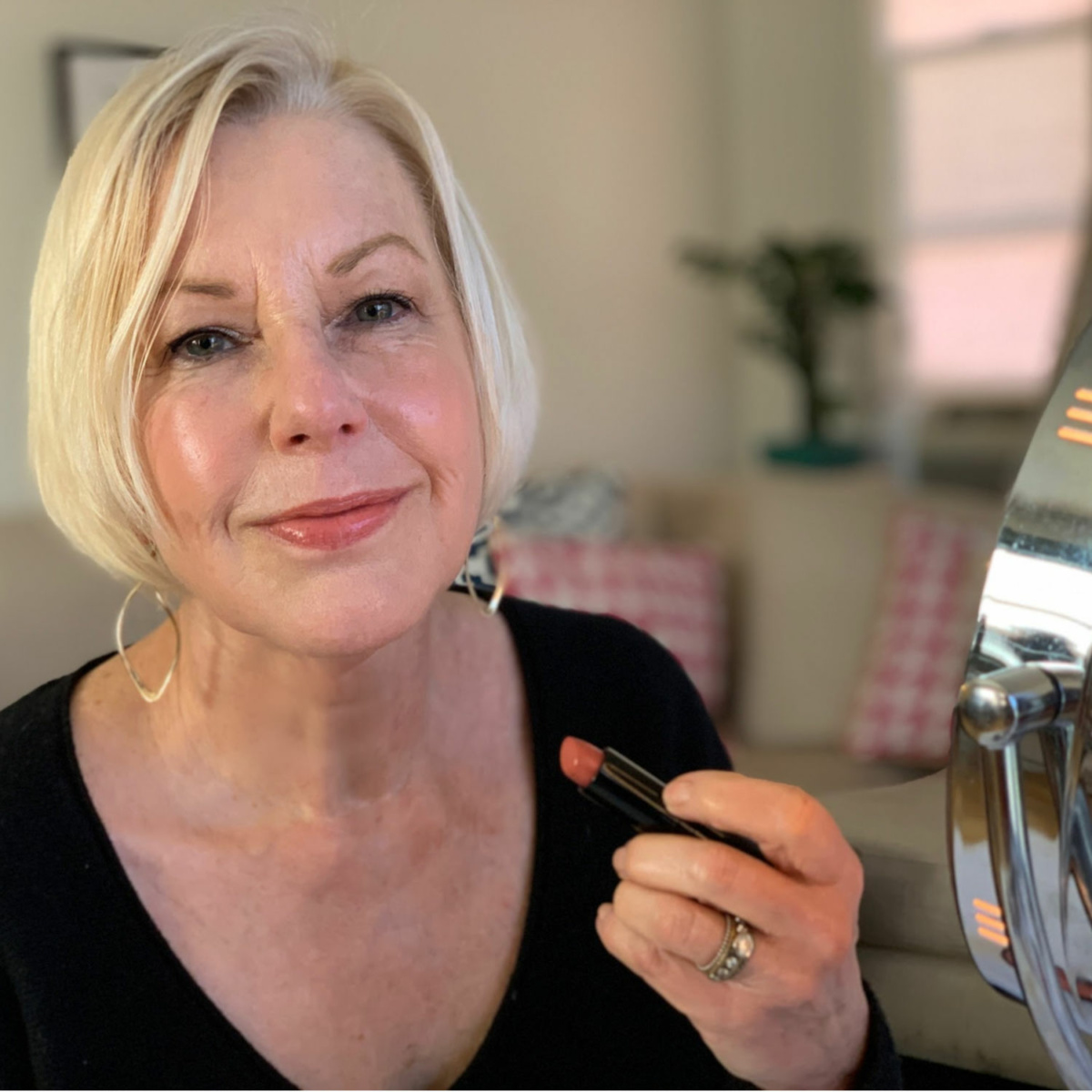Susan B. of une femme d'un certain age wears Makeover Workshop Sheer Moisture lipstick in Roj.