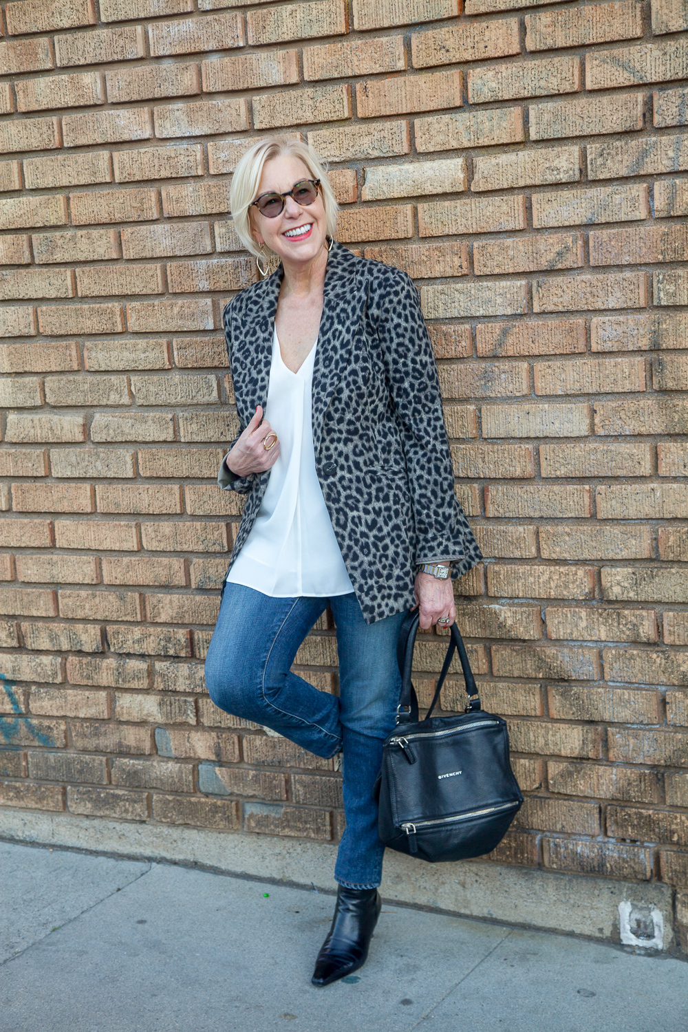 Style blogger Susan B. wears a cabi jacket in leopard print, slim-leg jeans and Givenchy small Pandora bag. Details at une femme d'un certain age.