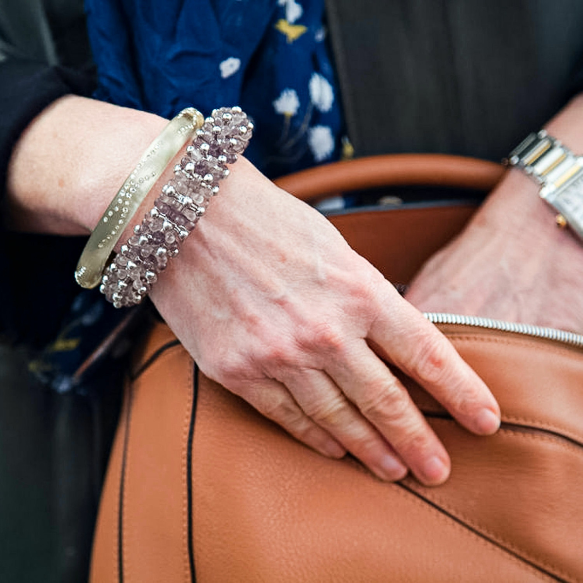 Detail: Susan B. of une femme d'un certain age wears bracelets from Alexis Bittar and COS.