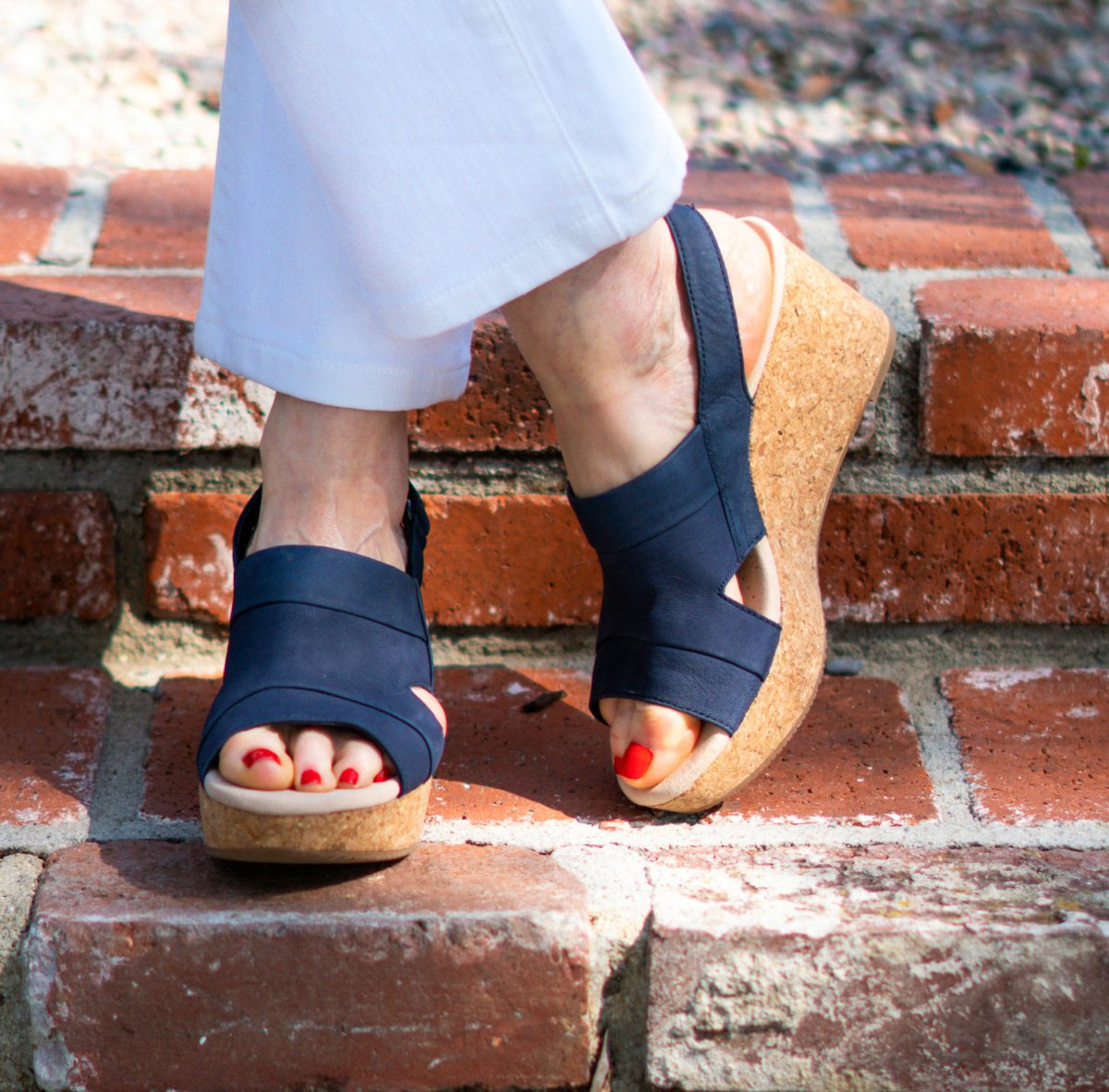 Detail: Susan B of une femme d'un certain age wears blue Clarks platform sandals.