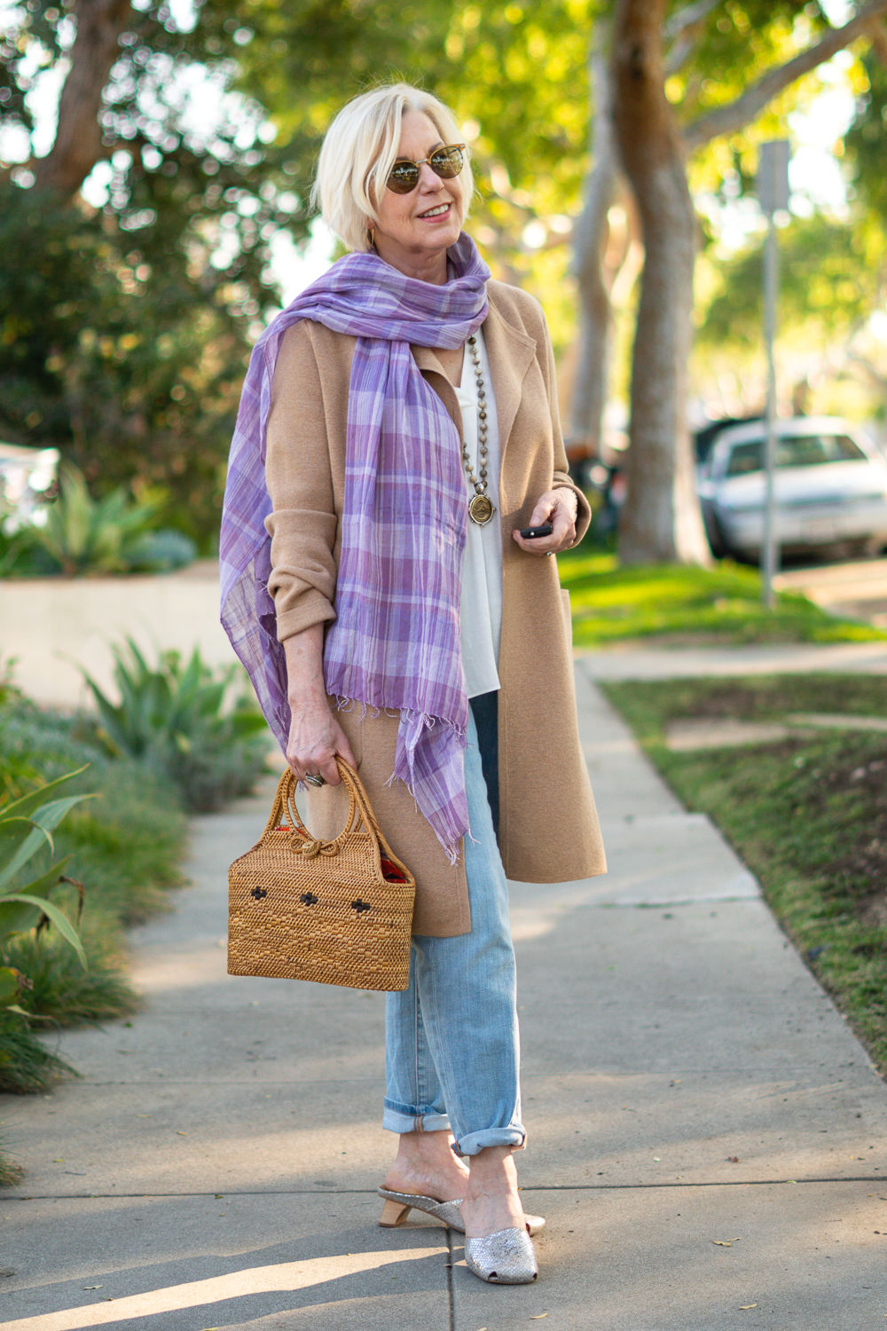 Susan B of une femme d'un certain age wears a casual look with camel sweater coat, lavender scarf and metallic mules.
