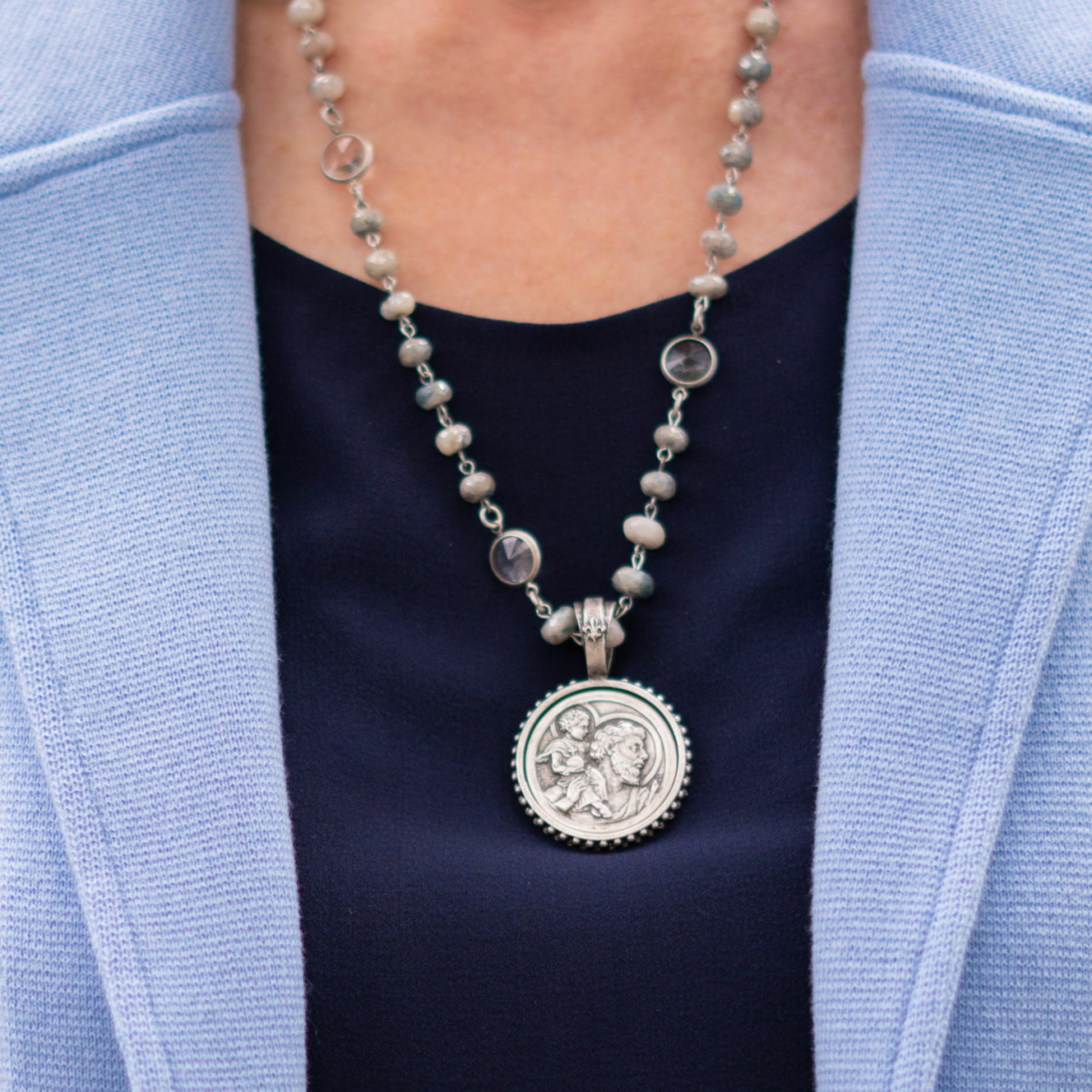 Susan B of une femme d'un certain age wears a French Kande silverite-Swarovski necklace with a St. Christopher medallion.