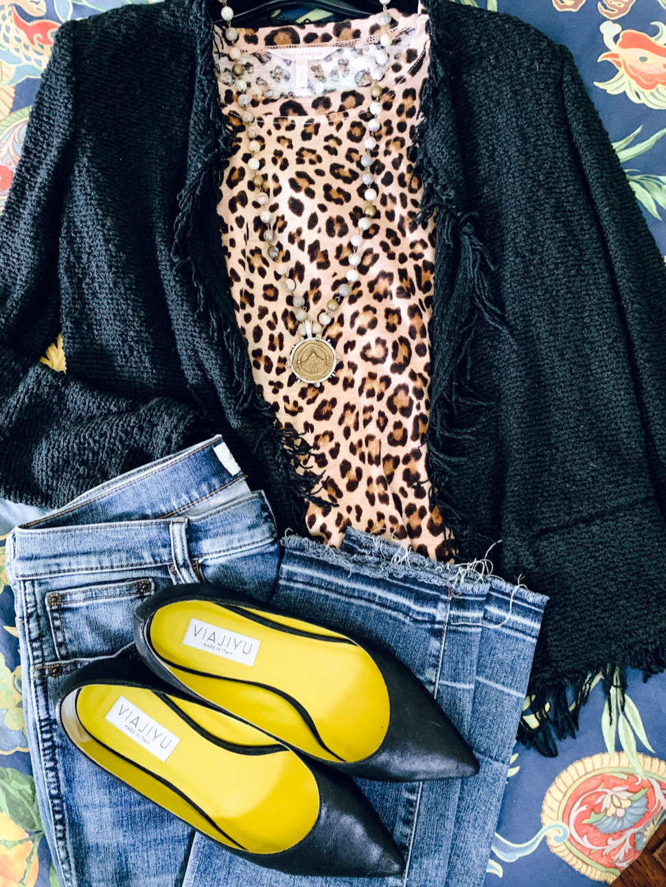 Outfit flat lay: leopard tee, fringe tweed jacket, French Kande necklace, black flats. Details at une femme d'un certain age.