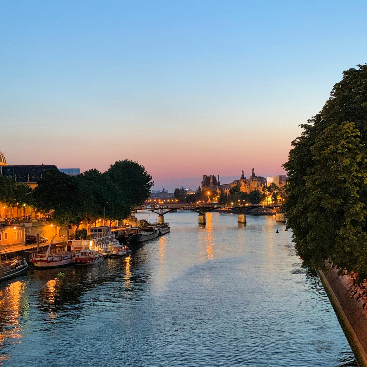 Looking westward along the Seine in Paris at dusk. Details at une femme d'un certain age.