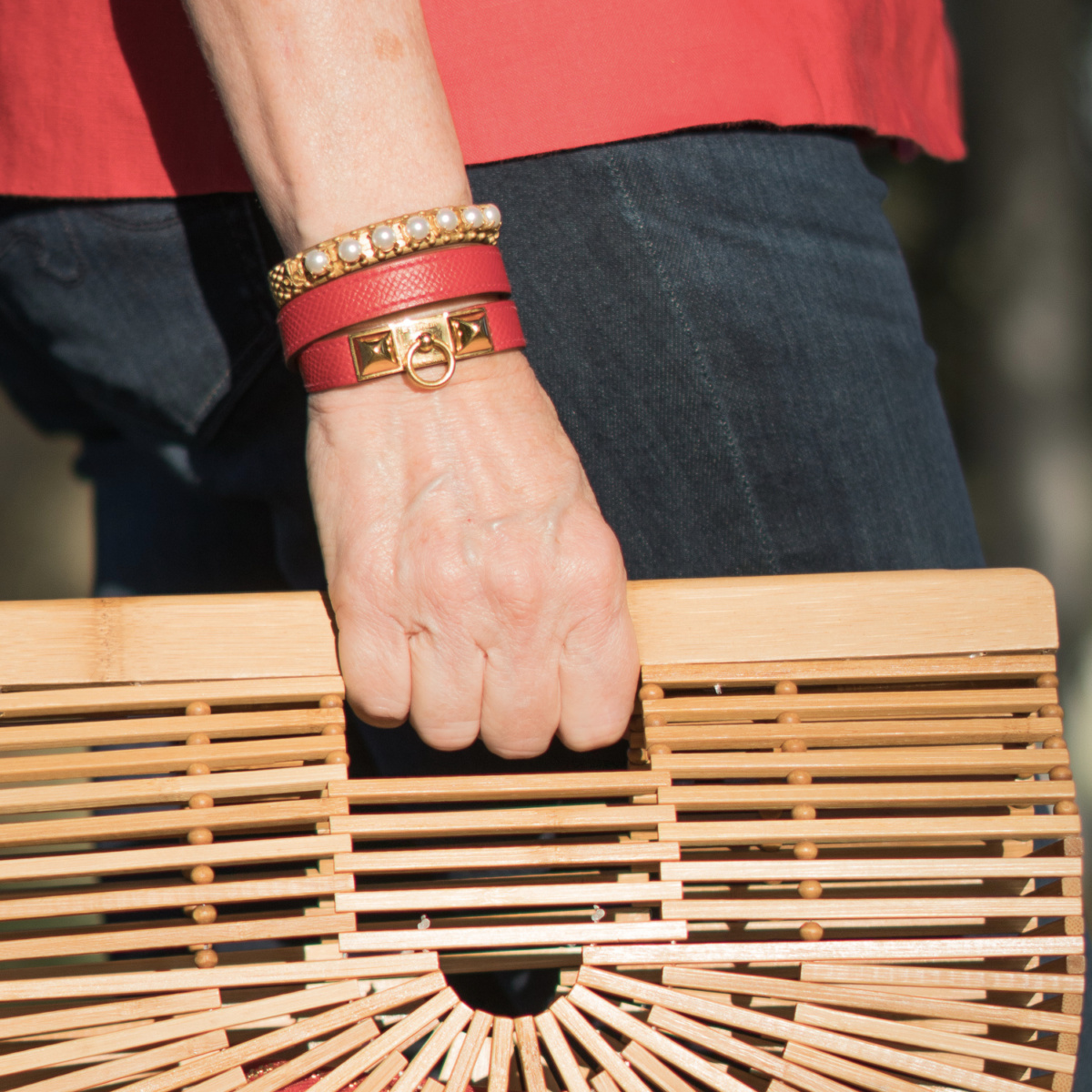 Susan B. of une femme d'un certain age wears Hermes leather bracelet and French Kande pearl studded cuff.