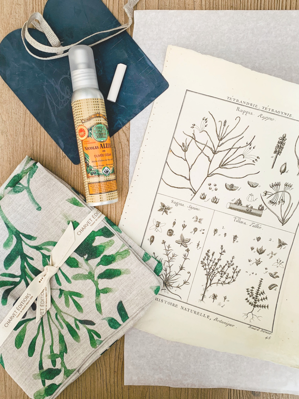 From the August My Stylish French Box: decorative pillow covers, gourmet olive oil, a miniature chalkboard and antique botanical print. Details at une femme d'un certain age.