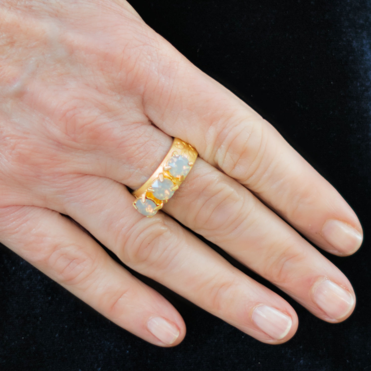 Detail: Susan B. wears a gold French Kande ring with grey opal Swarovski crystals. Info at une femme d'un certain age.