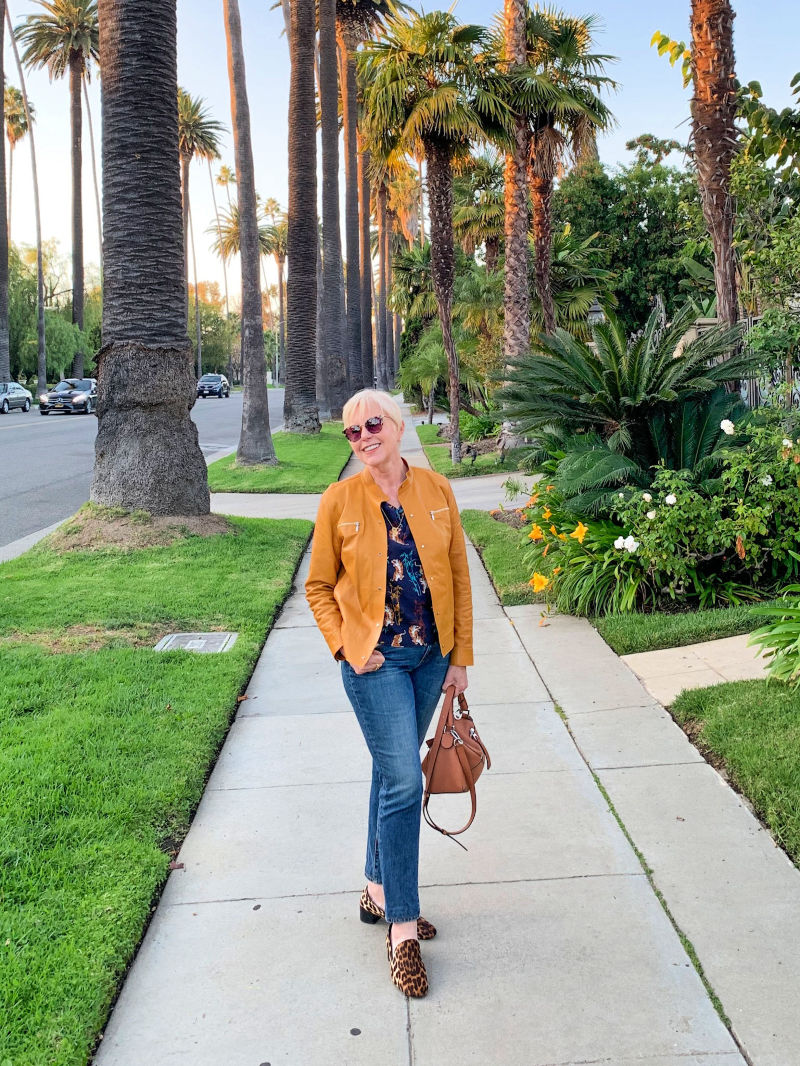 Style evolution: adding color and pattern to a neutral wardrobe. Susan B. of une femme d'un certain age wears a yellow leather jacket, tiger print shirt and leopard loafers.