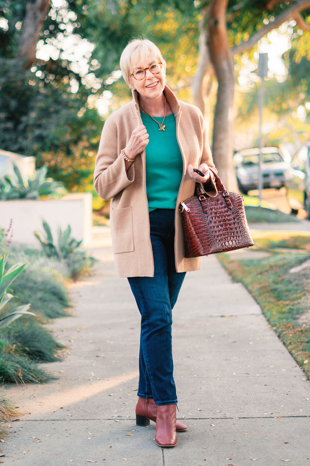 How to add color to a neutral wardrobe: Susan B. wears a turquoise sweater, jeans, tan sweater blazer and gold jewelry.