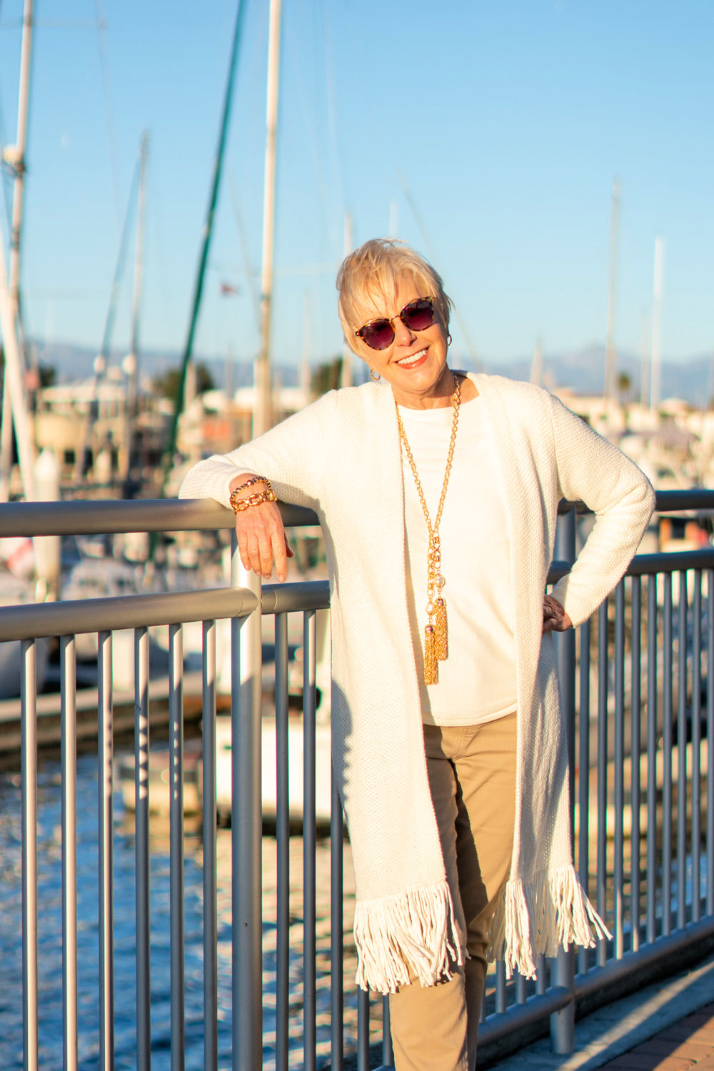 Style blogger Susan B wears a fringed cardigan, gold jewelry from Chicos. Details at une femme d'un certain age.