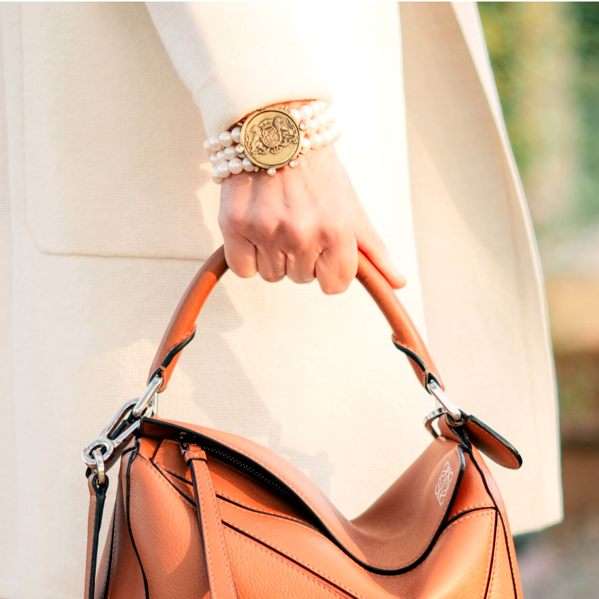 Detail: French Kande pearl bracelet and Loewe small puzzle bag. Info at une femme d'un certain age.