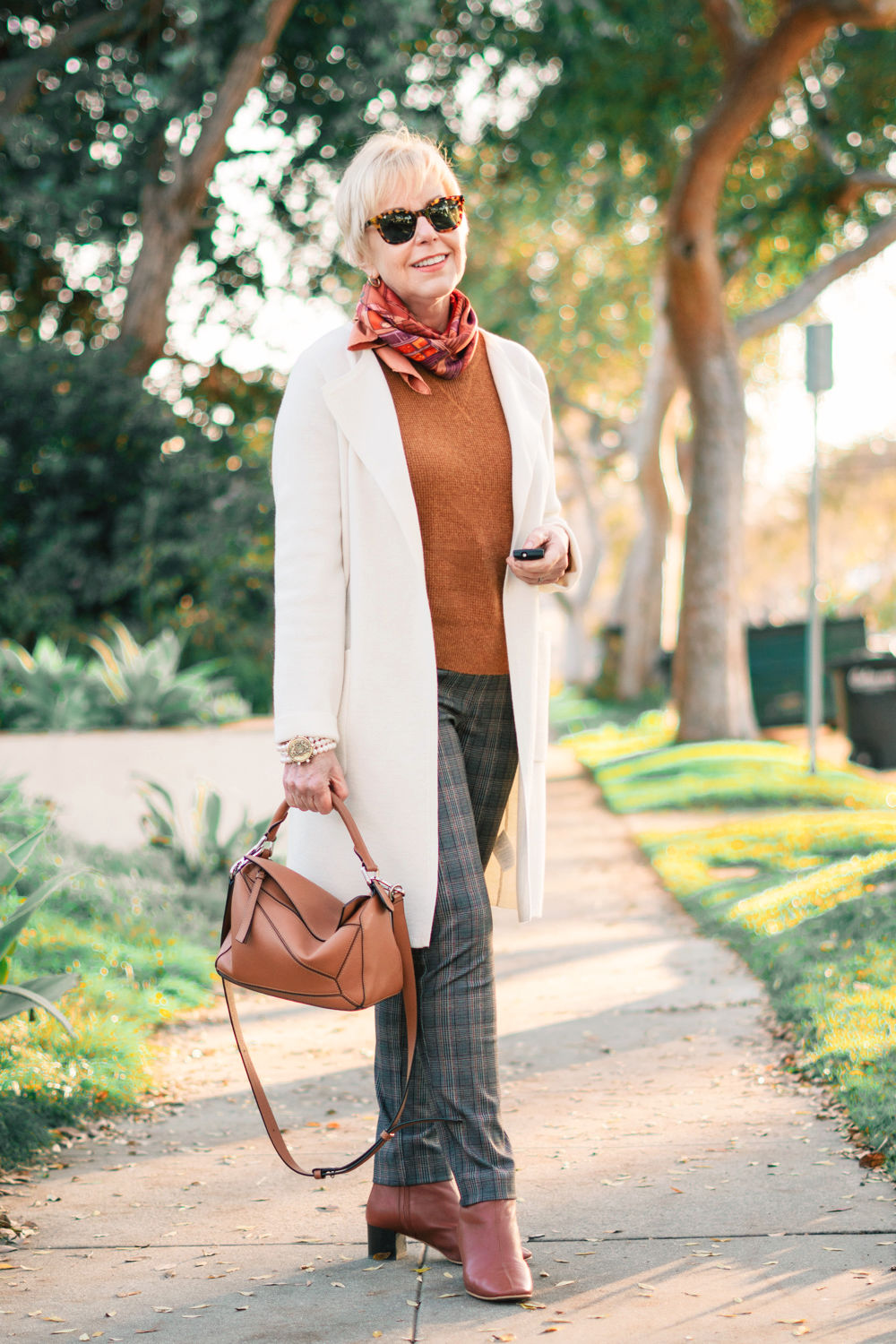 Susan B of une femme d'un certain age wears a casual outfit with plaid leggings, sweater-coat and boots.