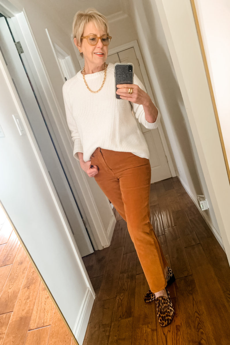 Luxe casual Thanksgiving outfit. Susan B. wears a rib knit cashmere sweater, brown corduroy jeans, leopard print loafers and gold link jewelry. Details at une femme d'un certain age.
