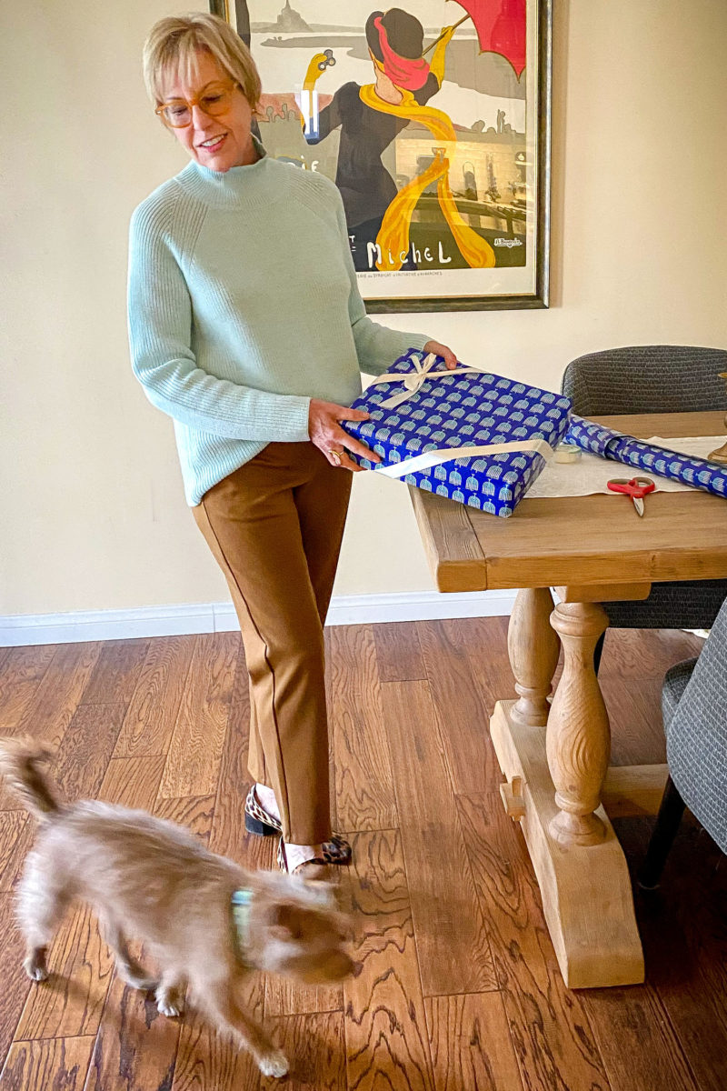 Wrapping Hanukkah presents. Susan B wears a cozy holiday outfit with a merino wool turtleneck and ponte knit pants from EILEEN FISHER. Details at une femme d'un certain age.