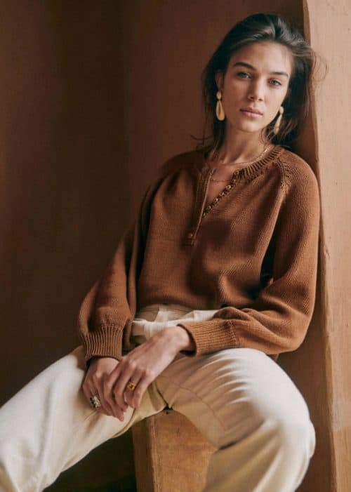 Sezane organic cotton sweater with button detail at neck.