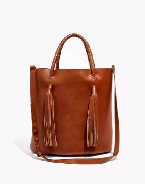 Madewell tasseled bucket bag in brown leather.