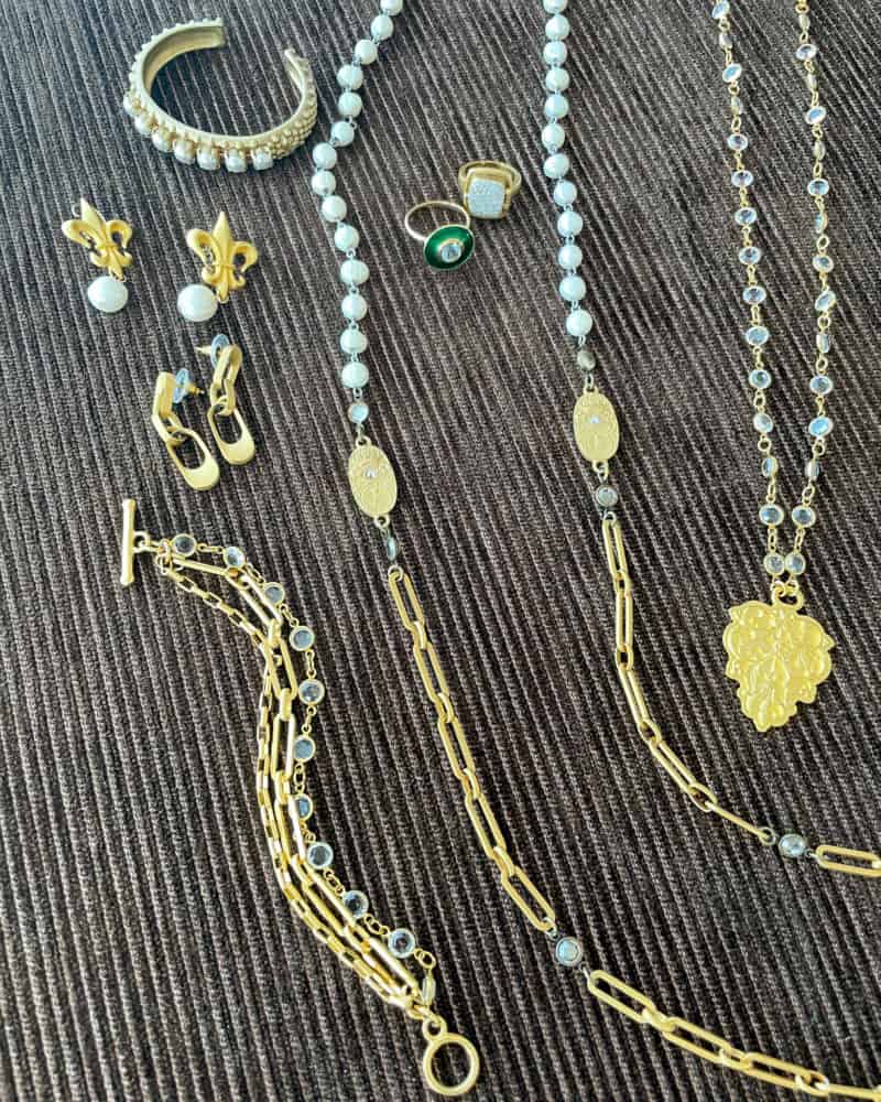 Travel jewelry capsule detail. Gold chains and pearls.