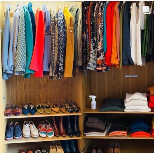 A neatly arranged closet organized by color.