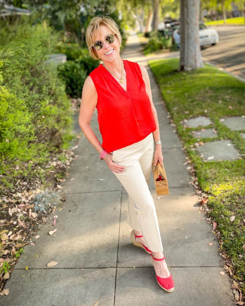 A "smart casual" summer outfit: Susan wears a red sleeveless top, Theory cotton twill trousers, red espadrilles.