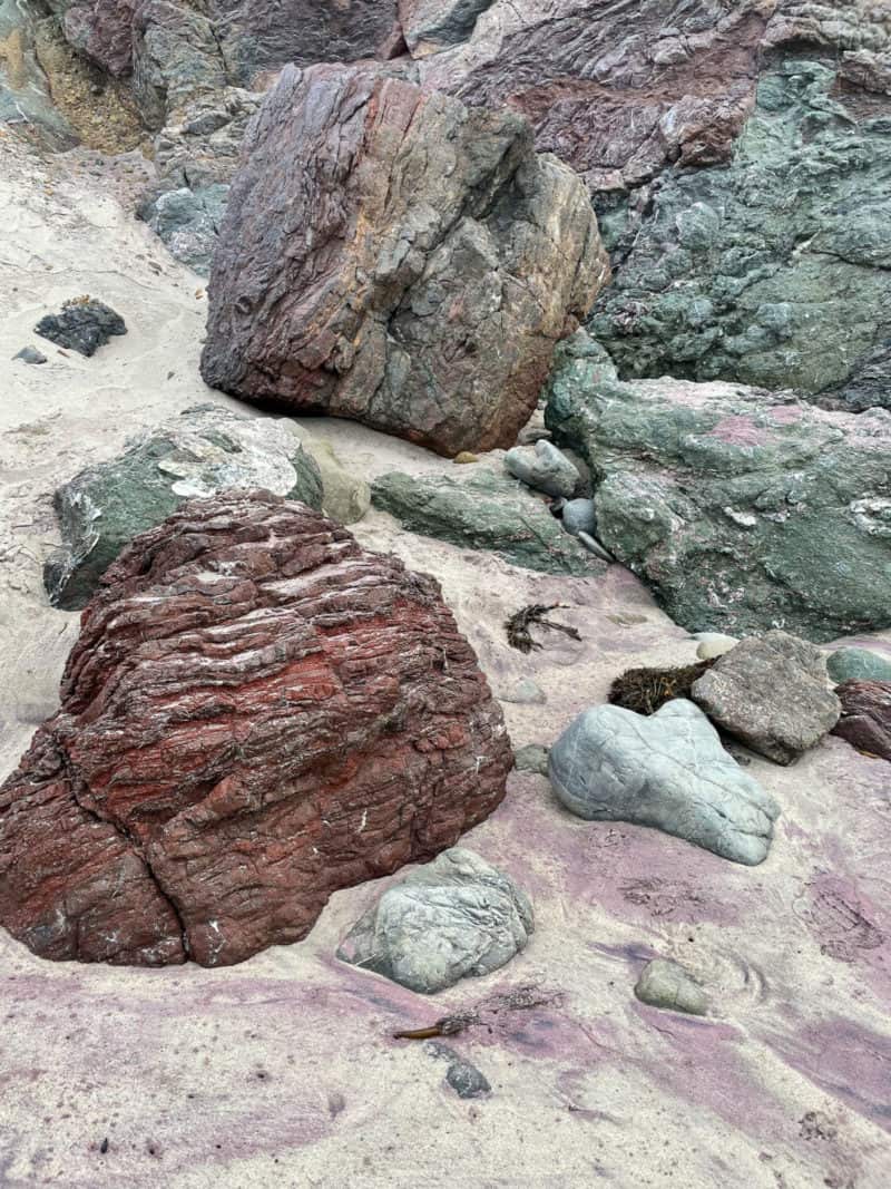 Purple sand at Pfeiffer Beach in Big Sur is a result of manganese garnet deposits washing down onto the beach.