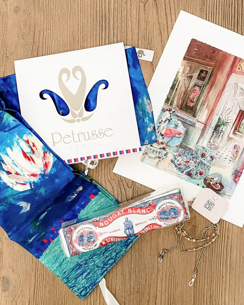 Goodies from My French Country Home box for August: a silk scarf, a nougat bar, and charming Michel Charrier watercolor print.