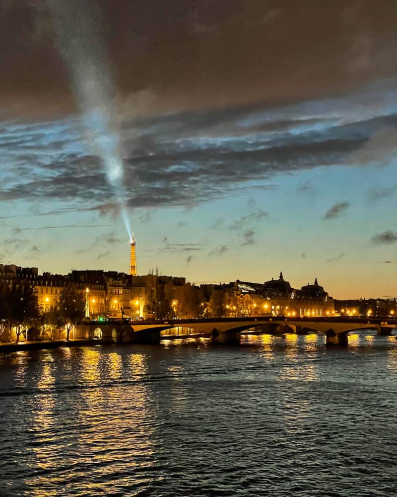 Light from the Eiffel Tower viewed from Pont des Arts, evening.