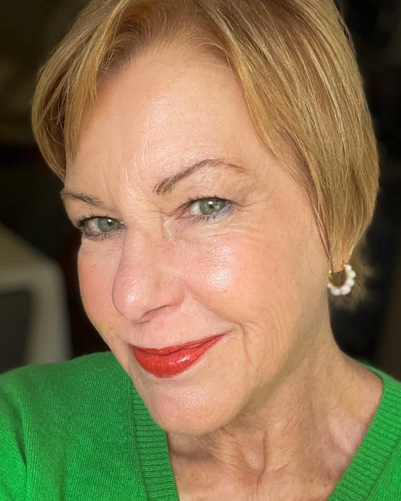 Susan B. wears a glam makeup look with red lipstick. Yes, you can wear red lipstick over 60!