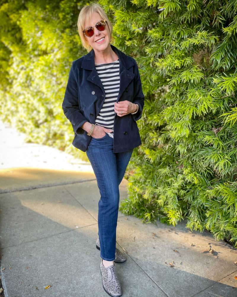 Susan B. wears a velveteen navy peacoat, navy striped tee, slim jeans, and metallic detail oxfords.