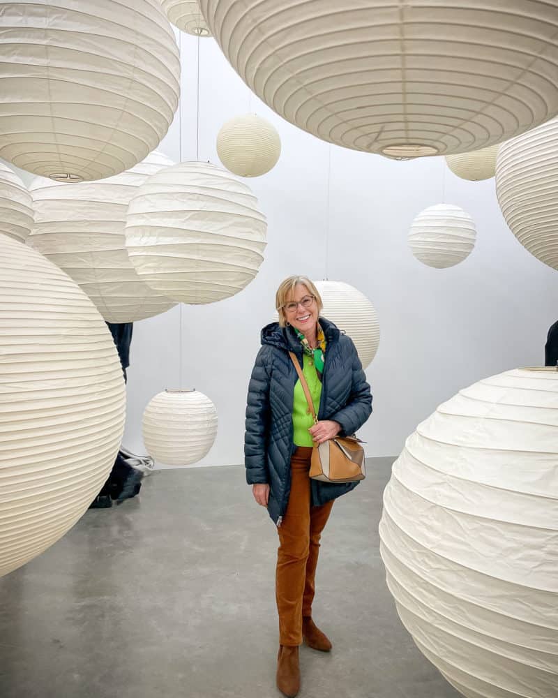 Susan B. among paper lantern sculpture at white cube gallery London.