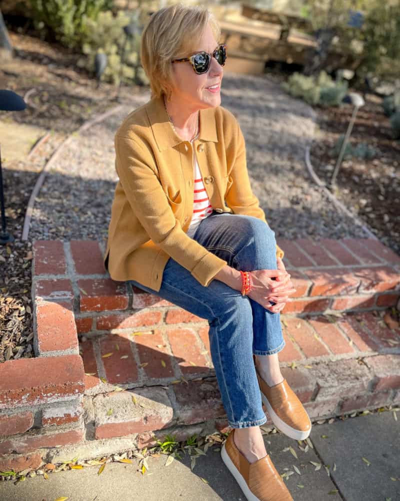 Susan B. wears a Madewell knit chore jacket, Kule striped tee, boyfriend jeans and Vince slip-on sneakers.