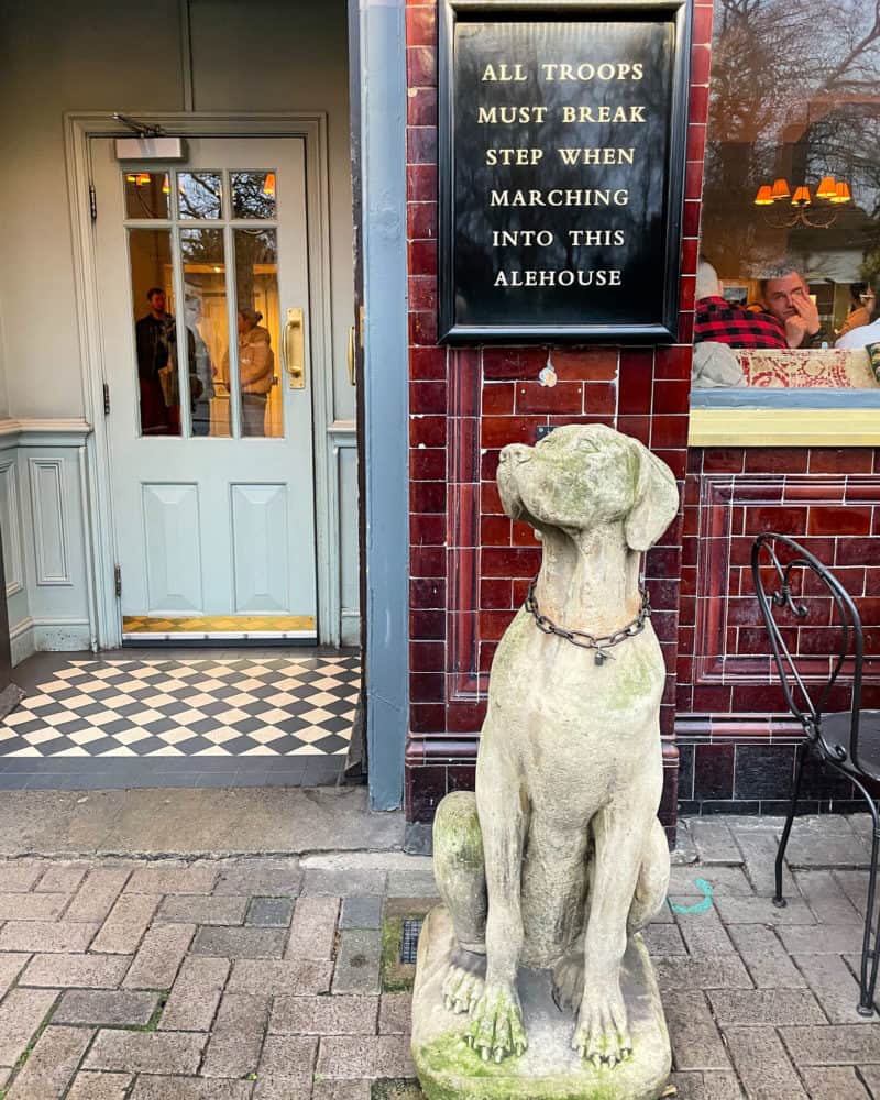 Sign and dog statue outside Albert pub in London.