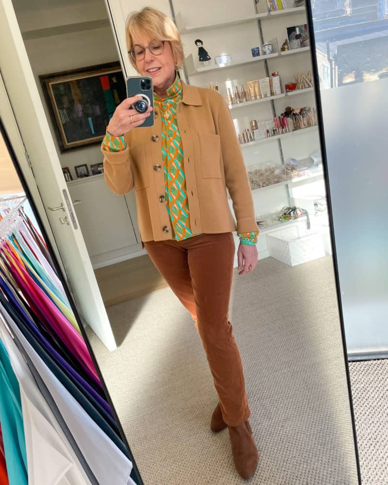 Susan B. wears a Madewell knit chore jacket, Siyu printed shirt, brown corduroy jeans & boots. How to build a color-coordinated wardrobe and shop efficiently.