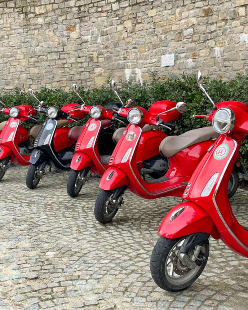 Red scooters lined up outside of Villa d'Amelia in Piedmont Italy