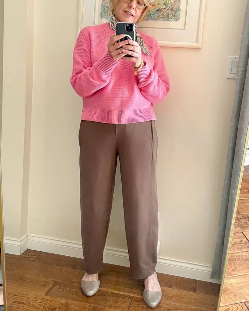 Susan B. wears a print bandana, pink sweater, brown Eileen Fisher lantern pants, metallic flats.
