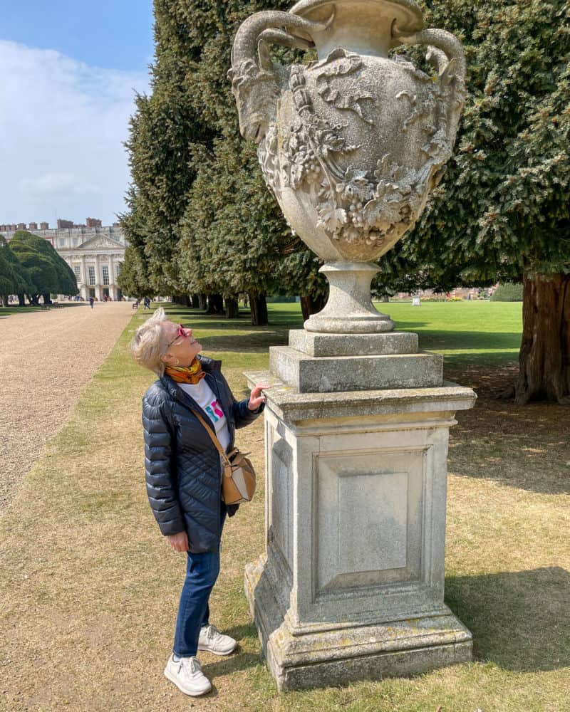Susan B examines an urn in Hampton Court Palace garden.